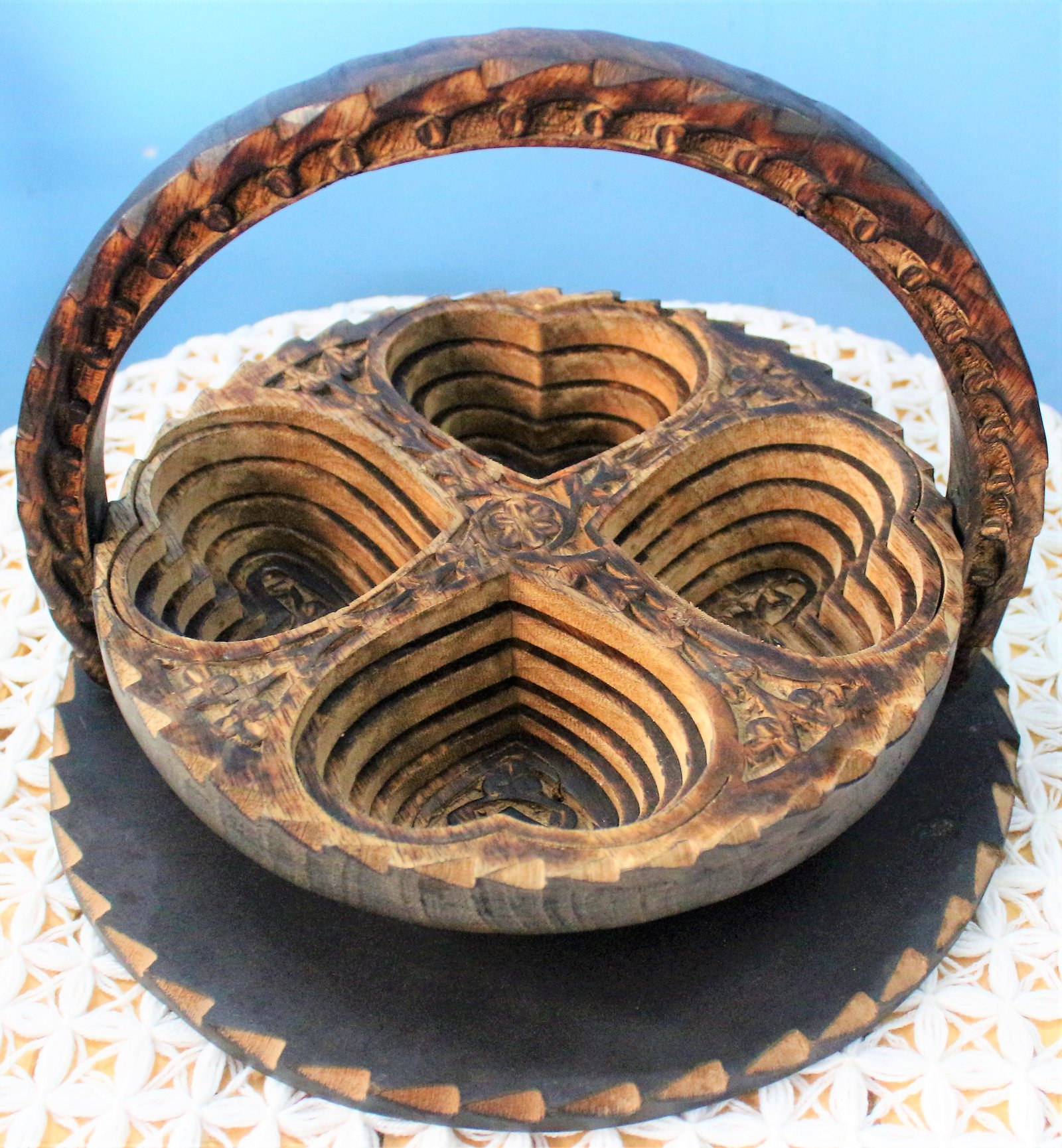 A unique, collapsible wooden basket.