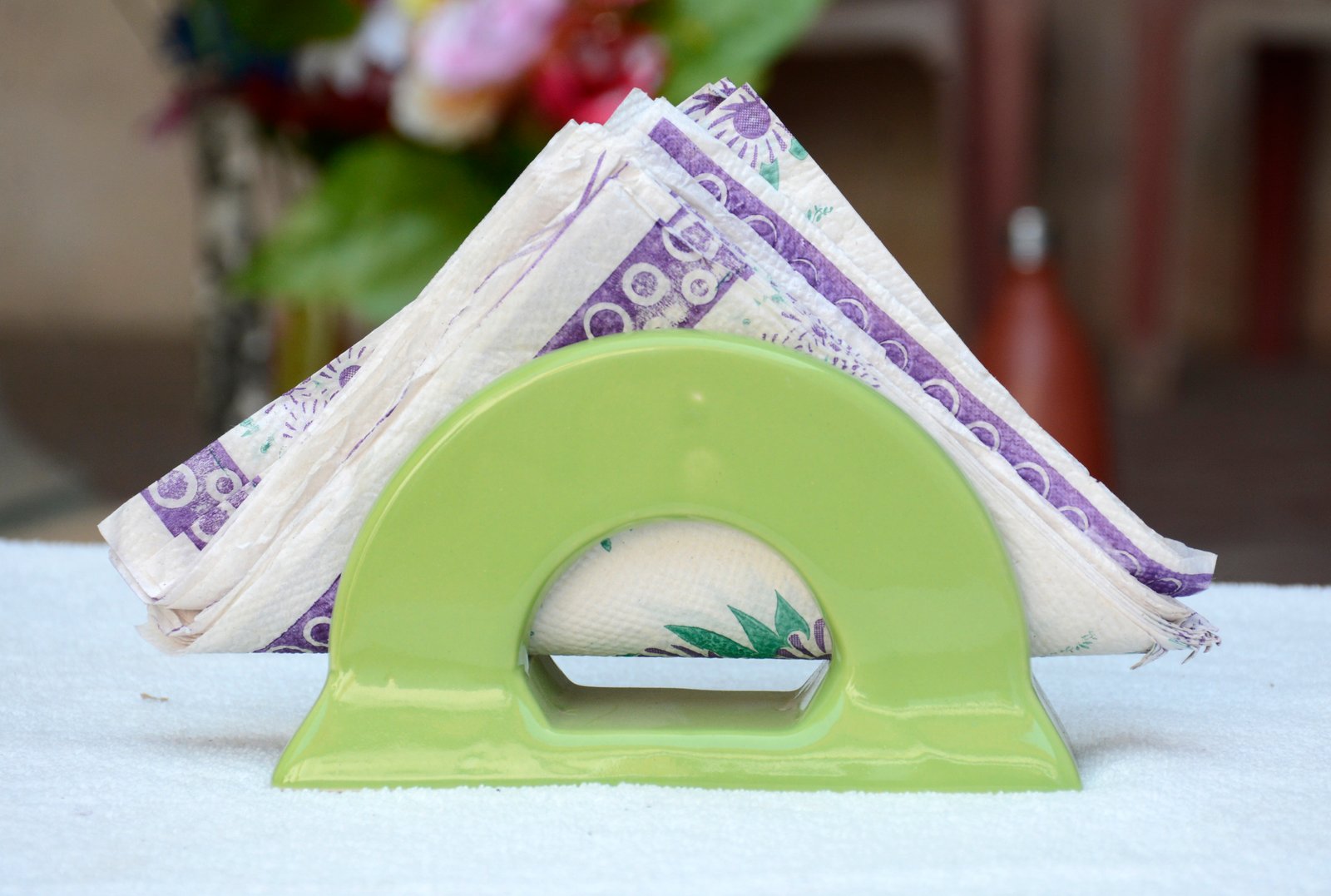 A bright green, ceramic or plastic napkin holder.