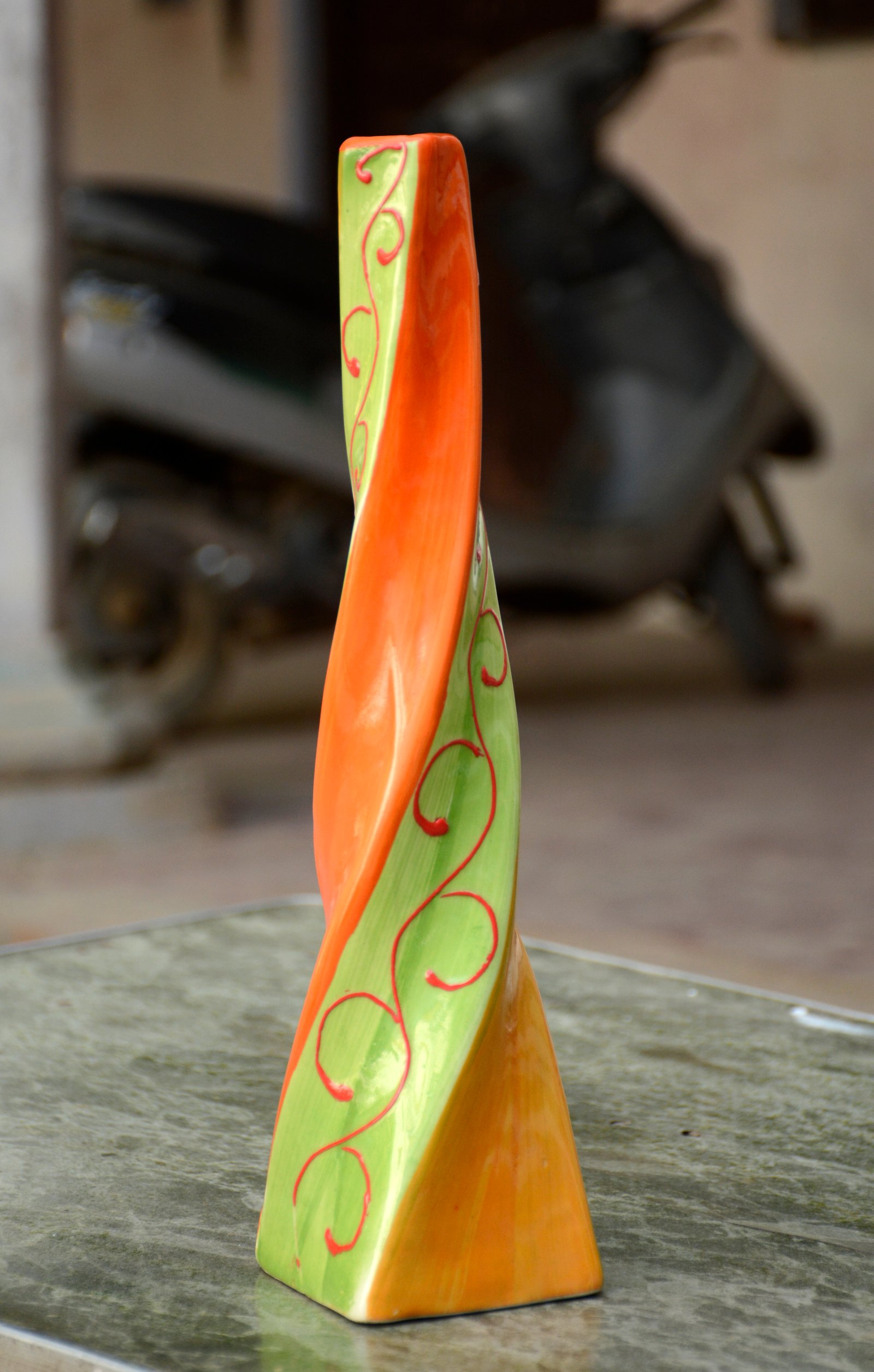 A vibrant and uniquely shaped ceramic vase